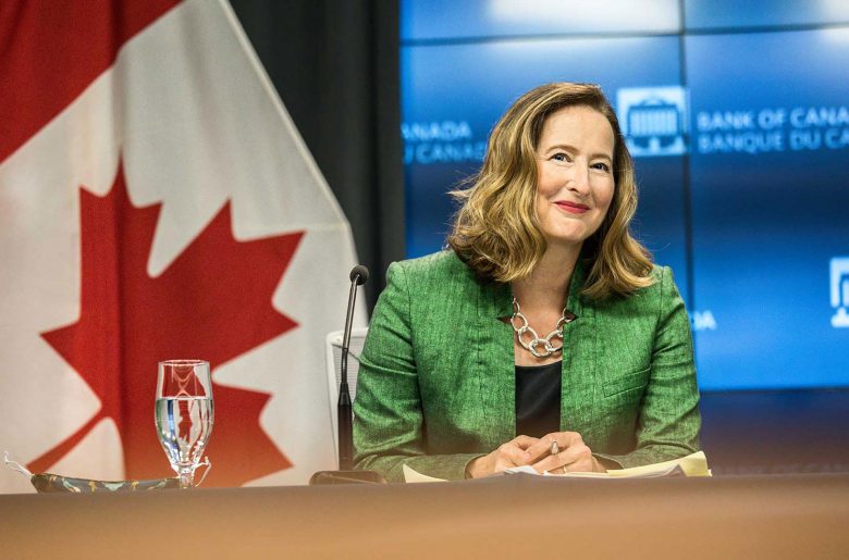 Carolyn A. Wilkins smiling while sitting at a table in the Bank of Canada’s press conference room.