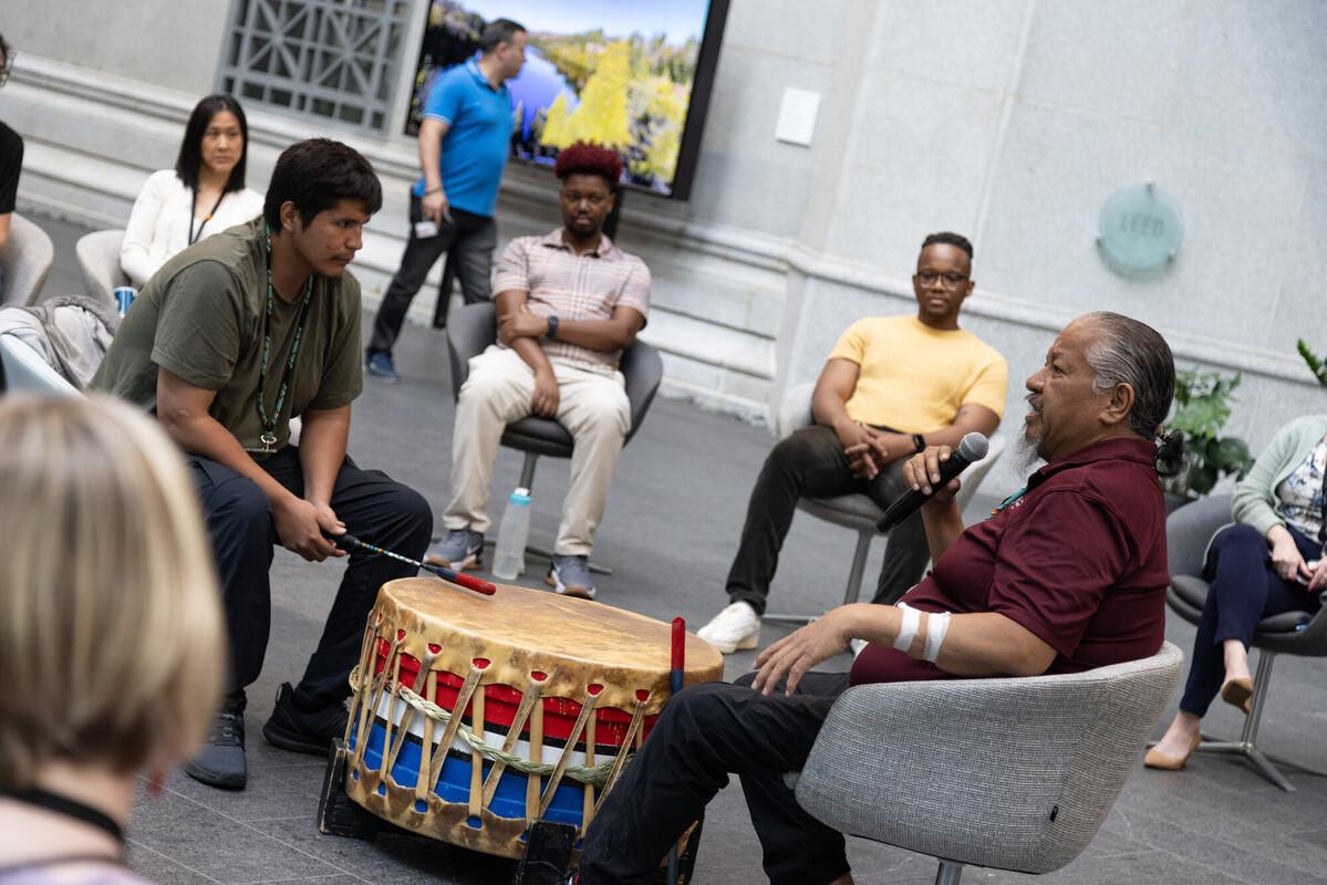 Ottawa River Singers discuss drumming at the Bank of Canada Audience members watching the Ottawa River Singers discuss drumming